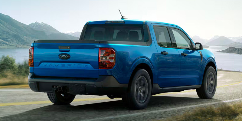 A 2025 Ford Maverick driving on a scenic highway near New Hudson, MI