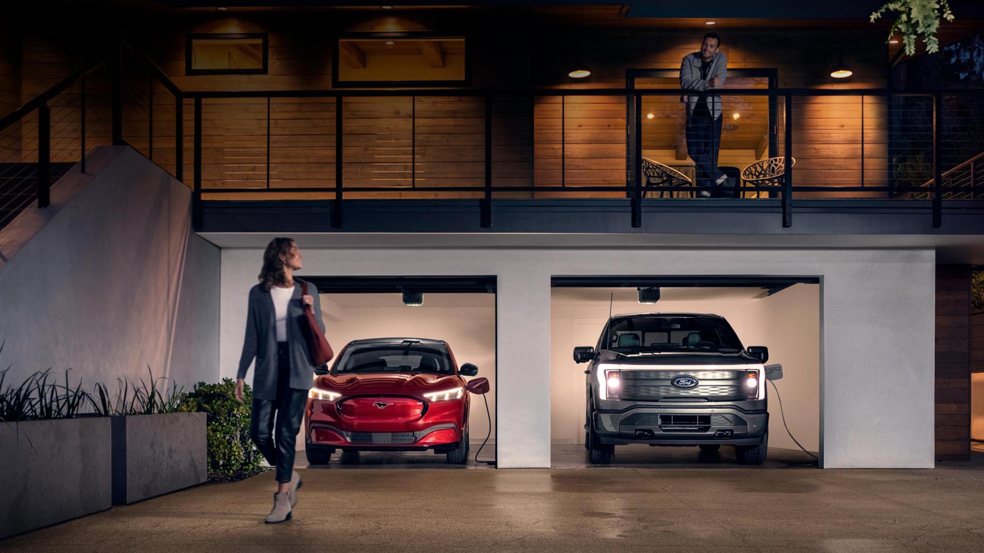 A woman stands in a garage next to a fuel-efficient Ford model, highlighting top options for 2026.