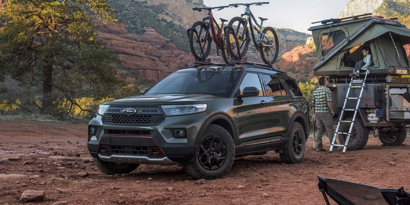 Ford Explorer parked in the desert with bikes on the roof