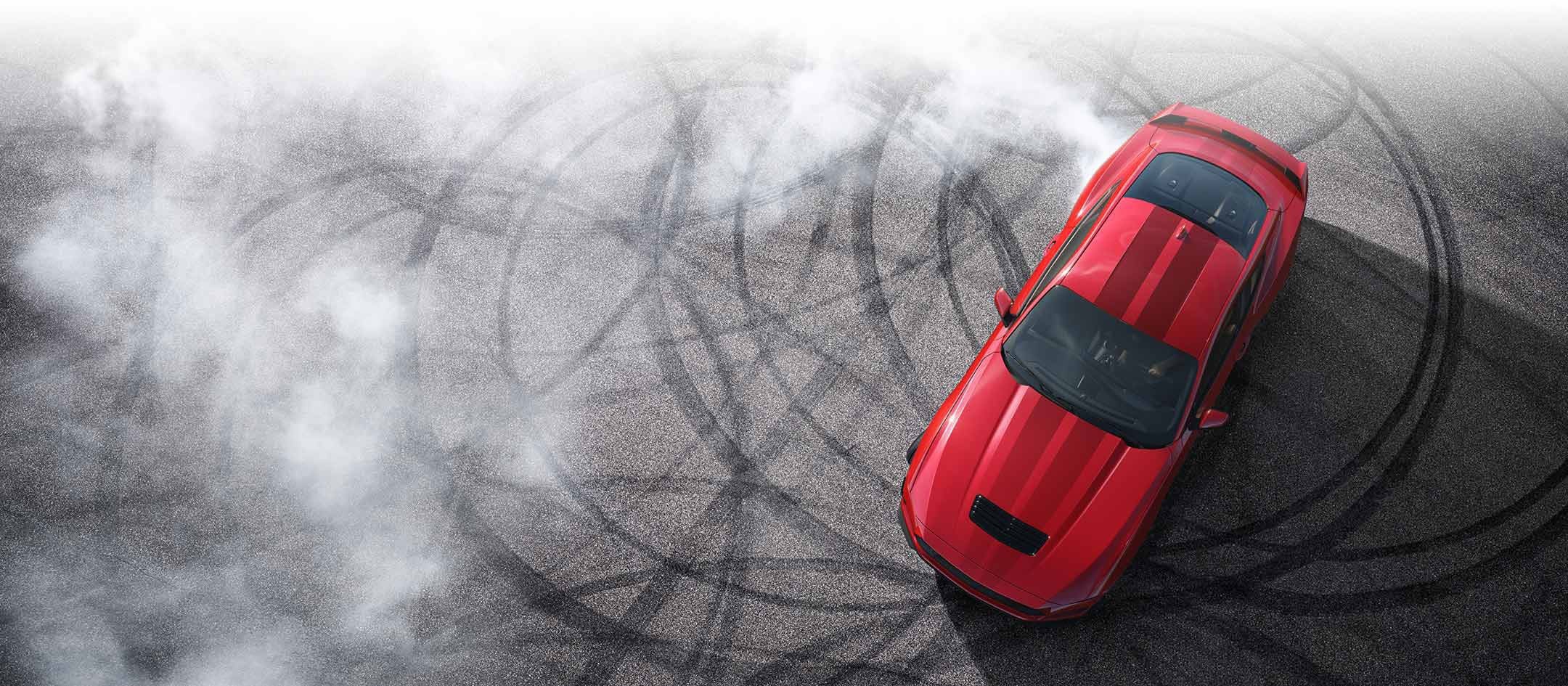 Overhead view of a 2024 Ford Mustang® model with tire tracks on pavement | Hines Park Ford in New Hudson MI