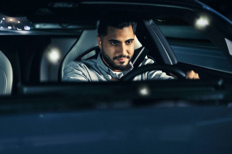 Person sitting in the driver’s seat of a parked 2024 Ford Mustang® coupe | Hines Park Ford in New Hudson MI