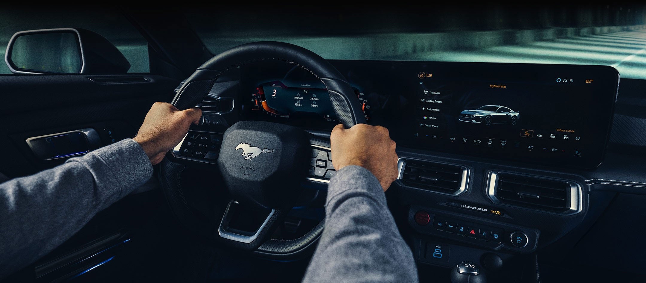 A 2024 Ford Mustang® model interior with a person driving | Hines Park Ford in New Hudson MI