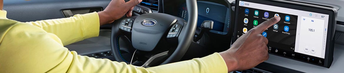 A driver at the wheel of their 2025 Ford Maverick in New Hudson, MI