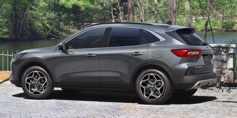 2026 Ford Escape side profile in New Hudson, MI showcasing aerodynamic lines and alloy wheels along local streets