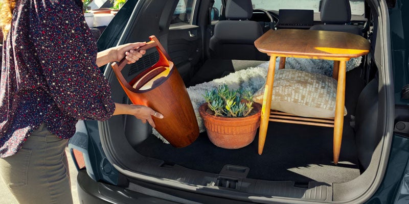 2026 Ford Escape in New Hudson, MI showing full cargo space with seats folded and trunk organization features