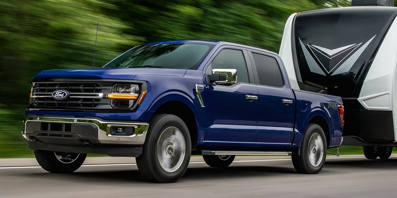 2026 Ford F-150 performance driving in New Hudson MI showing powerful engine capability and smooth handling on Michigan roads and highways