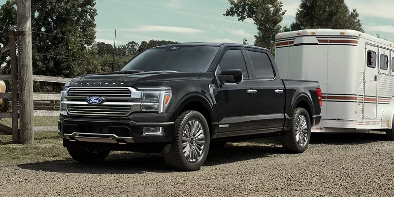2026 Ford F-150 trim levels in New Hudson MI showcasing XL, XLT, Lariat, King Ranch, Platinum, Tremor, and Raptor model variations