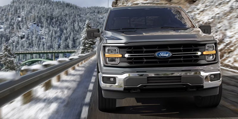 2026 Ford F-150 winter driving in New Hudson MI on snowy Michigan highway conditions with enhanced traction and driver assistance features