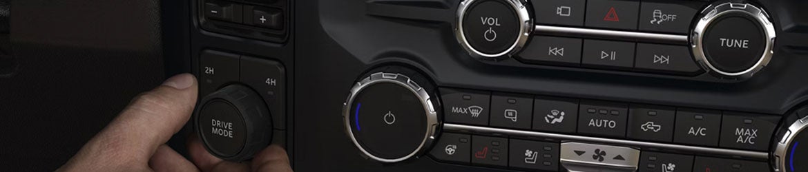 2026 Ford Super Duty center console controls in New Hudson MI showing integrated towing buttons, drive mode selectors, and advanced truck command interface
