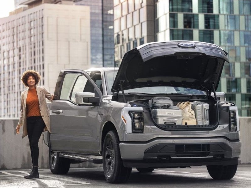 Ford F-150 Lightning parked with front truck opened and full of luggage