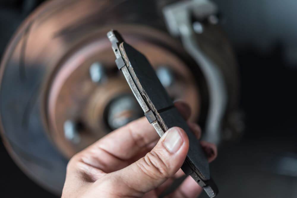 Close up of mechanic holding brake pad