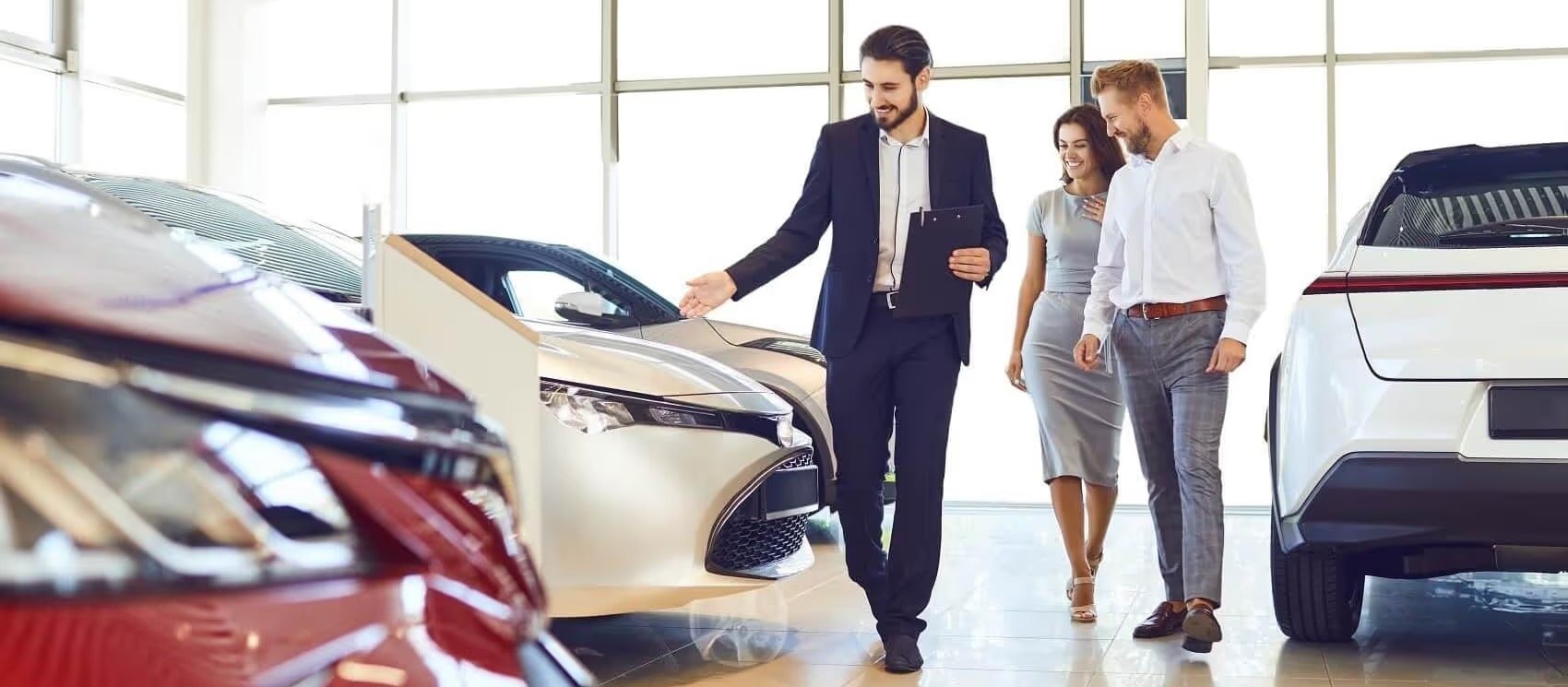 Ford Team member showing Ford vehicles to couple before discussing finance options